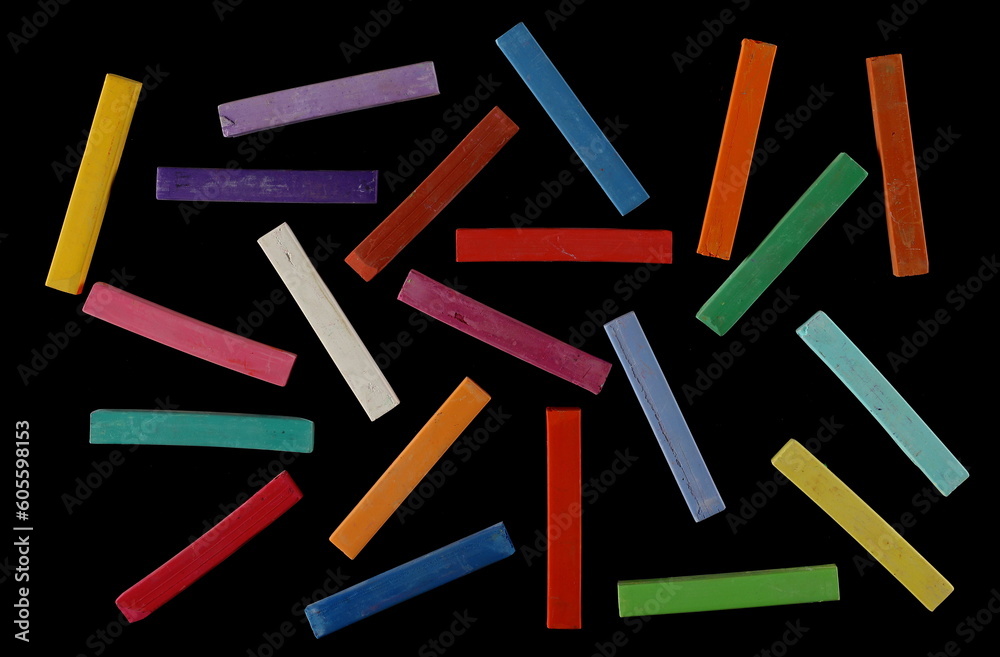Colorful set chalks pattern isolated on black background, top view Colorful set chalks pattern isolated on black background, top view
