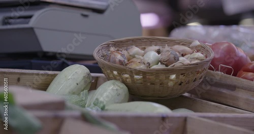 
Assorted fruit, vegetables and fish in wooden baskets at village market