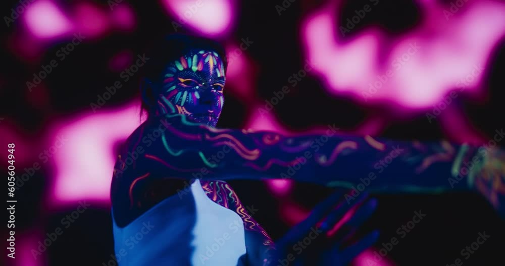 Creative Young Female Covered in Neon Body Paint Performing Modern Dance Choreography in a Studio with Abstract Art Background. Beautiful Contemporary Dancer Expressing Her Inner World Through Dance