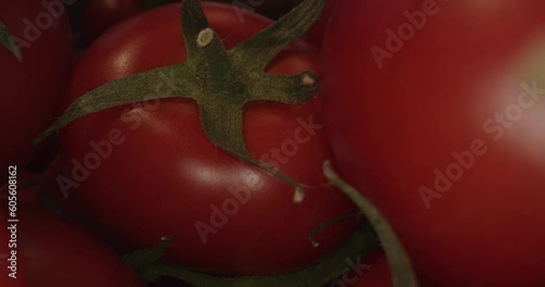red tomatoes in wooden box and with laowa optics in the foreground in motion
