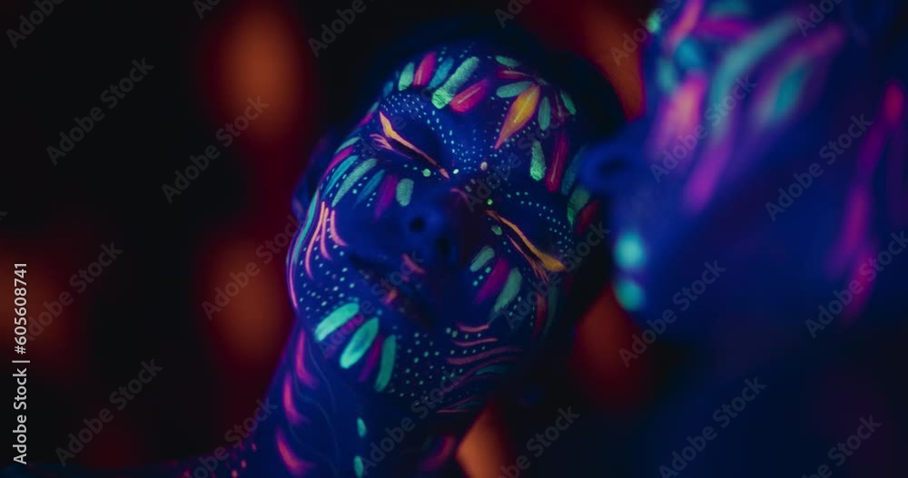 Young Girl Covered in Neon Paint Expresses Beauty, Femininity and Confidence as She Poses for Camera. Abstract Background and Mirror Reflection Enhances MIndful, Artistic and Spiritual Boho Aura Young Girl Covered in Neon Paint Expresses Beauty, Femininity and Confidence as She Poses for Camera. Abstract Background and Mirror Reflection Enhances MIndful, Artistic and Spiritual Boho Aura
