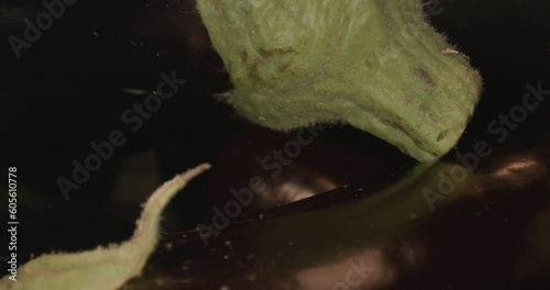 dark eggplant in wooden box and with laowa optics in the foreground in motion