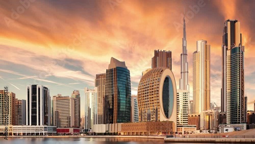 Time lapse of  Dubai skyline with Burj khalifa and other skyscrapers at sunset from Al Jadaf Waterfront; UAE