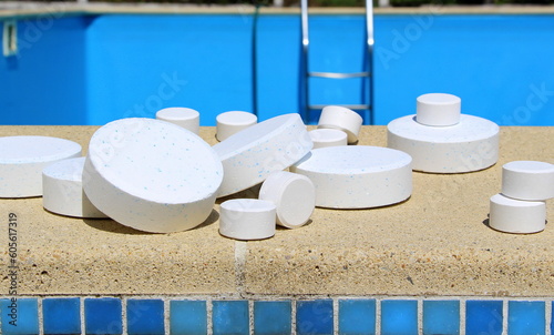 White large and mini chlorine tablet for swimming pool disinfection. The beginning of the swimming season is a hot summer. Maintenance of domestic and public pools.