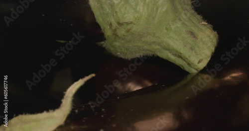 dark eggplant in wooden box and with laowa optics in the foreground in motion