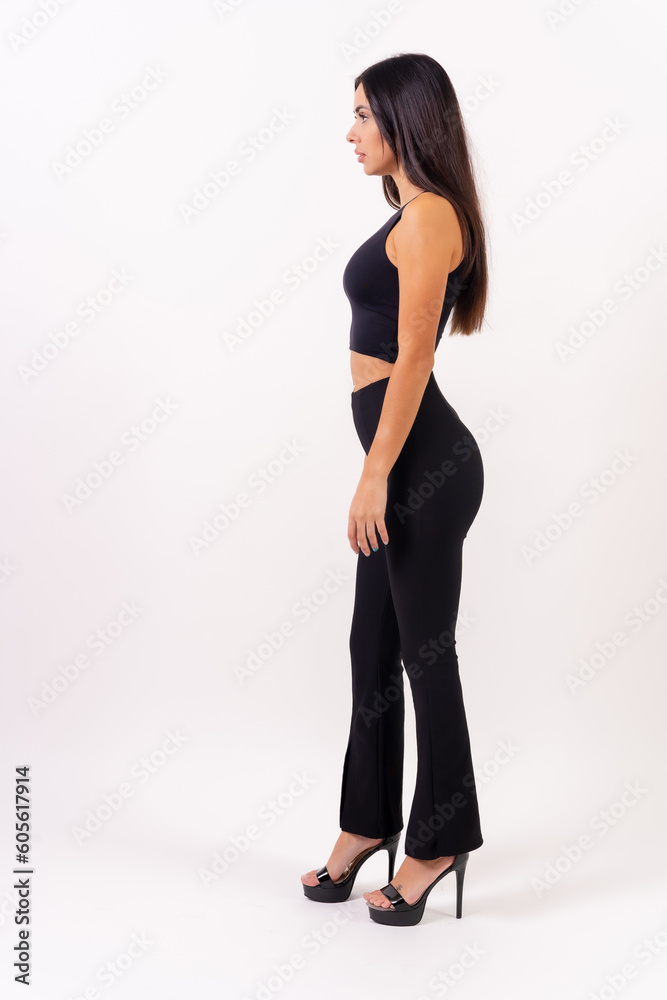 Person brunette woman in casting photos on a white background. Perched in profile dressed in black Person brunette woman in casting photos on a white background. Perched in profile dressed in black