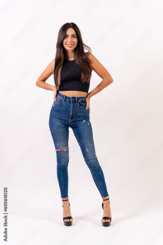 Brunette woman in casting photos on a white background, in jeans and a black t-shirt Brunette woman in casting photos on a white background, in jeans and a black t-shirt