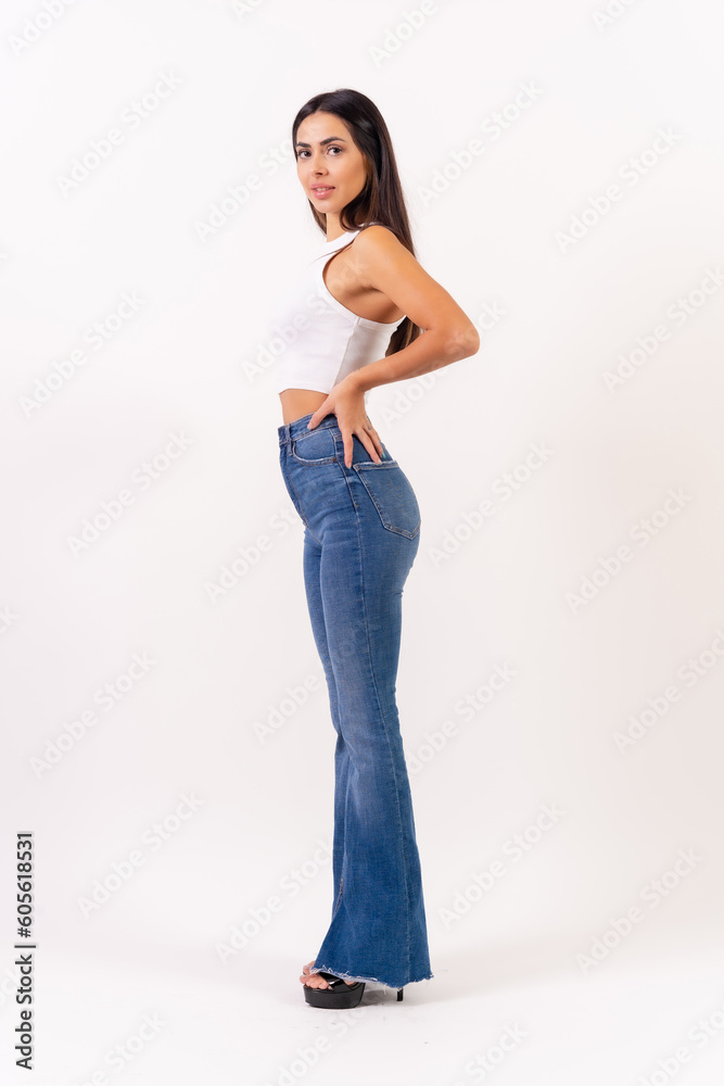Brunette woman on a white background, casting studio photos, portrait in a white t-shirt in profile Brunette woman on a white background, casting studio photos, portrait in a white t-shirt in profile