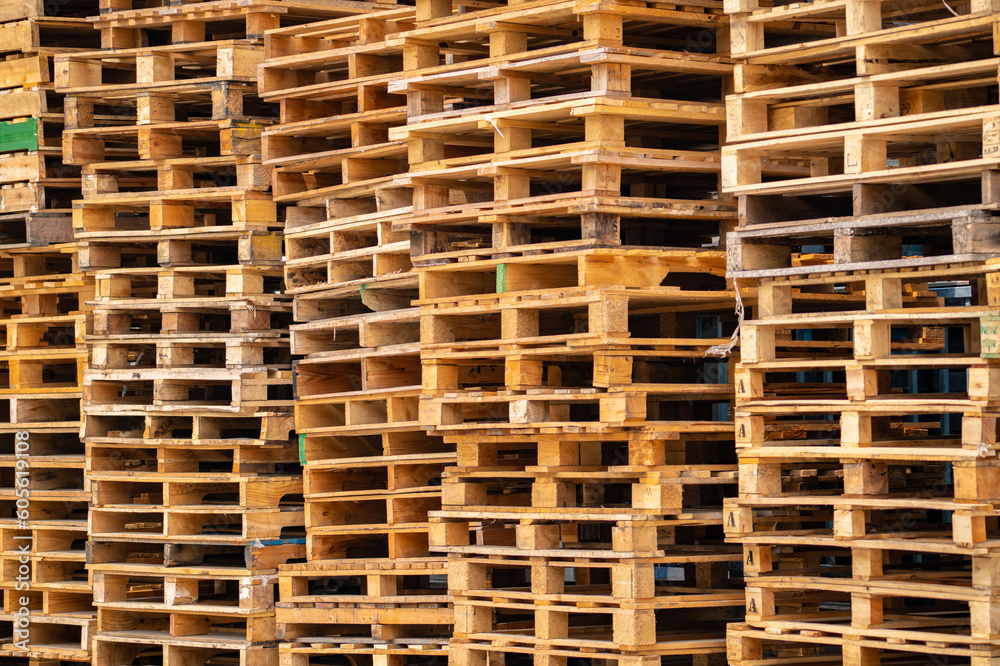 Stack of wooden pallet. Industrial wood pallet at factory warehouse. Cargo and shipping concept. Sustainability of supply chains. Eco-friendly nature and sustainable properties. Renewable wood pallet. Stack of wooden pallet. Industrial wood pallet at factory warehouse. Cargo and shipping concept. Sustainability of supply chains. Eco-friendly nature and sustainable properties. Renewable wood pallet.