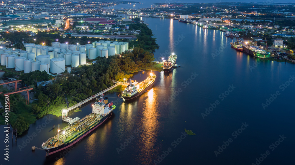 Aerial view oil storage tanks and tanker in river at night, Aerial view of oil storage tanks and tanker ship in the port town, Tanker ship in the port.