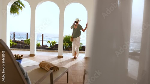 Elegant female tourist checking into luxury Mediterranean hotel 
