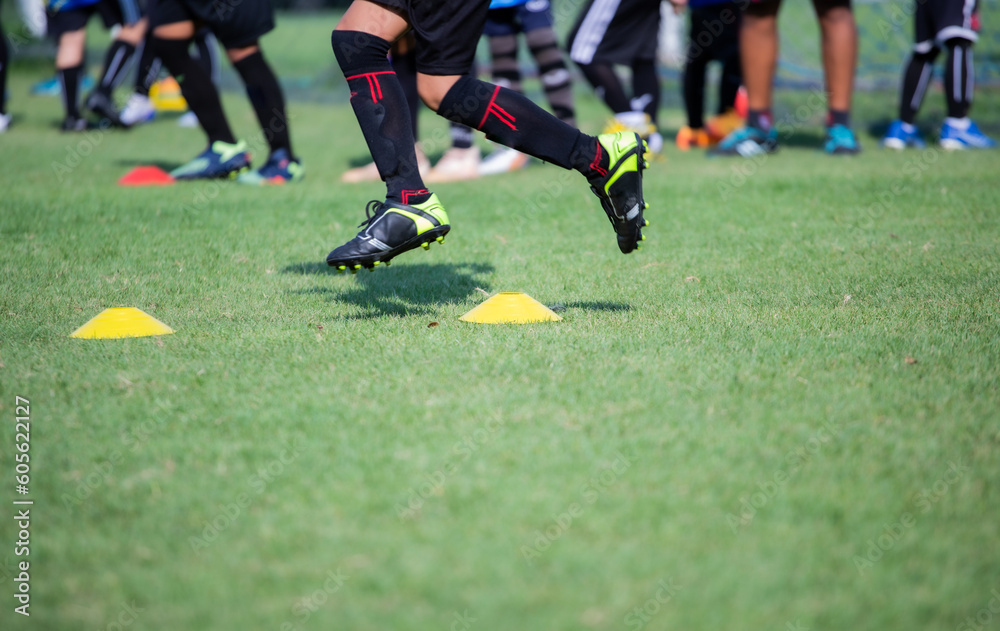 Athlete practicing running football sport on field equipment