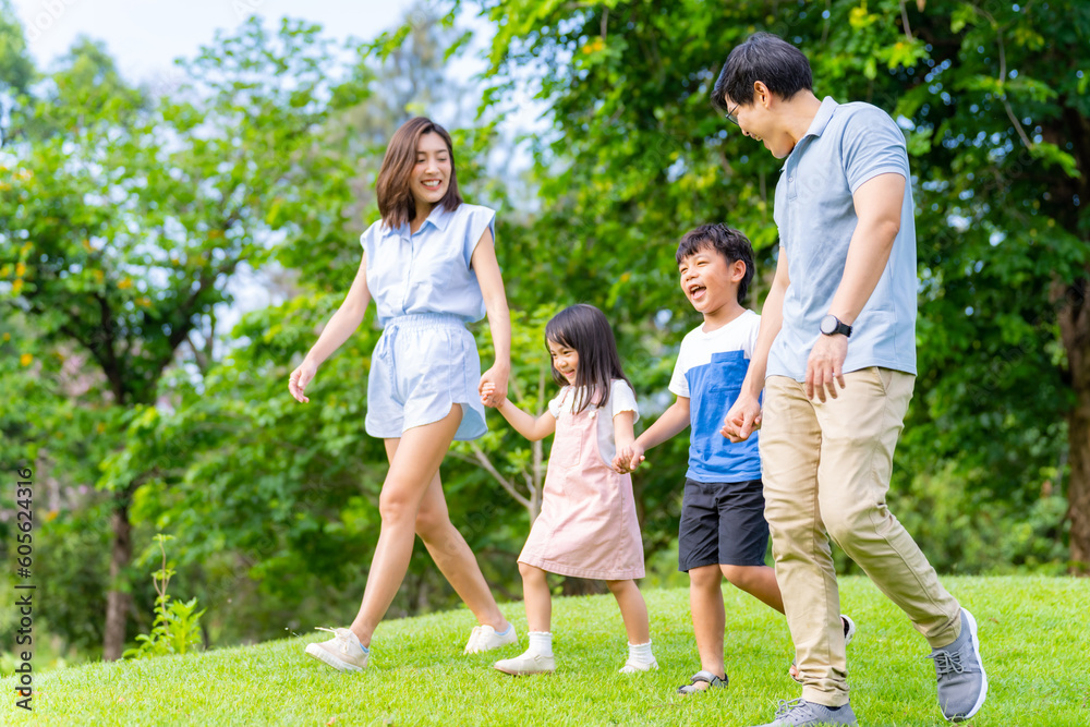 Happy Asian family spending time together travel on summer holiday vacation. Parent and little child enjoy and fun outdoor activity lifestyle walking and playing together at public park in the city. Happy Asian family spending time together travel on summer holiday vacation. Parent and little child enjoy and fun outdoor activity lifestyle walking and playing together at public park in the city.