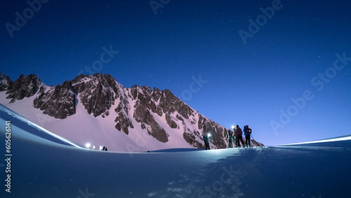 Φωτογραφία Skiers touring at night in the French alps in winter under the fullmoon light
