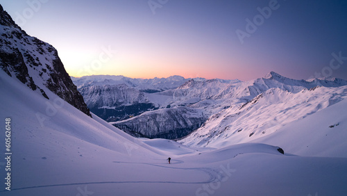 Skiers touring in winter, full of snow, at sunrise under a beautfiul clear sky full of colors. living the dream photo