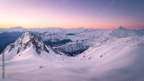 Beautfiul winter landscape in the mountains, at sunrise from the summit. Colors of sunrise, full of snow.