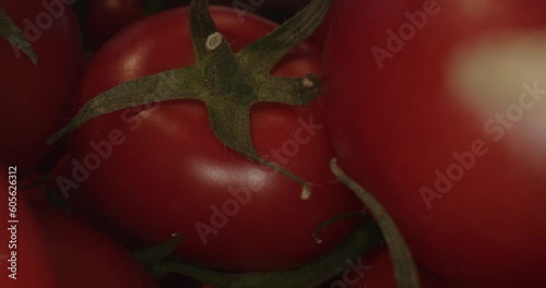 red tomatoes in wooden box and with laowa optics in the foreground in motion