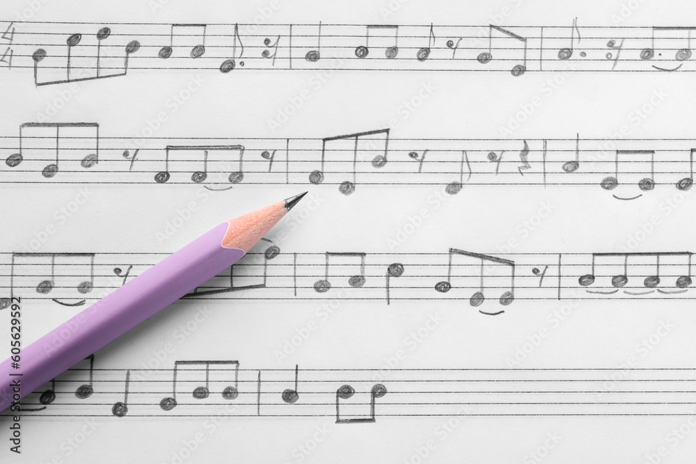 Sheet with musical notes and pencil, top view Sheet with musical notes and pencil, top view