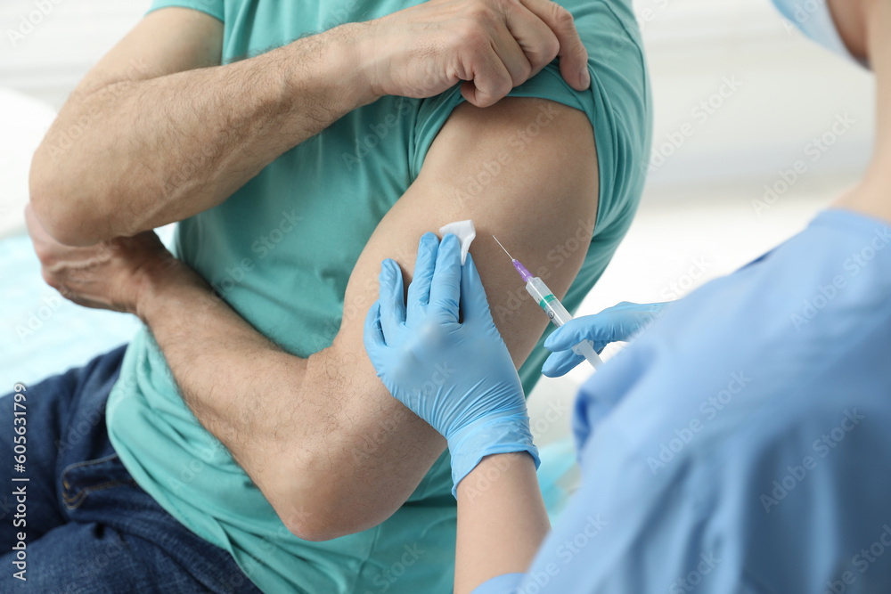 Fototapeta premium Doctor giving hepatitis vaccine to patient in clinic, closeup