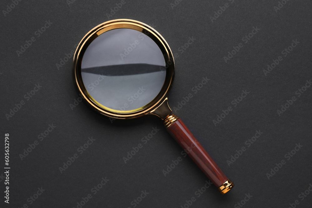 Magnifying glass on dark background, top view Magnifying glass on dark background, top view