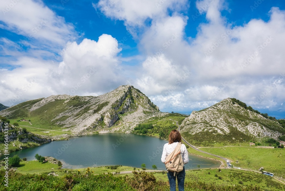 Female admiring a lake in a mountainous area