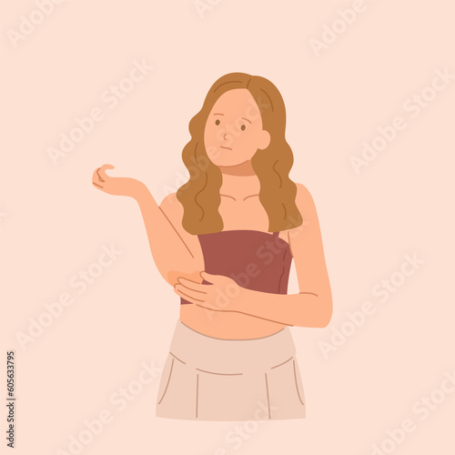 Young upset girl looks at her elbow.
