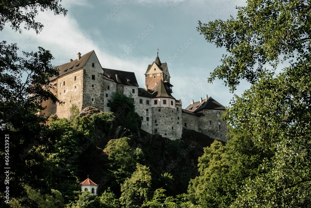 Beautiful Loket Castle in Czechia surrounded by green lush trees