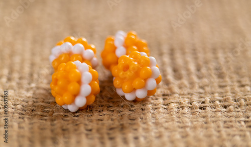 Bright orange textured beads with a white stripe