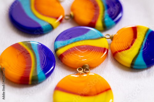The pendant is round in rainbow bright colors