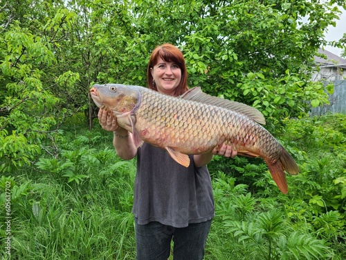 Woman holding a big carp