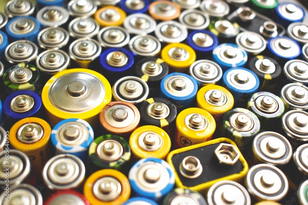 Closeup of variety of batteries standing in different sizes and colors