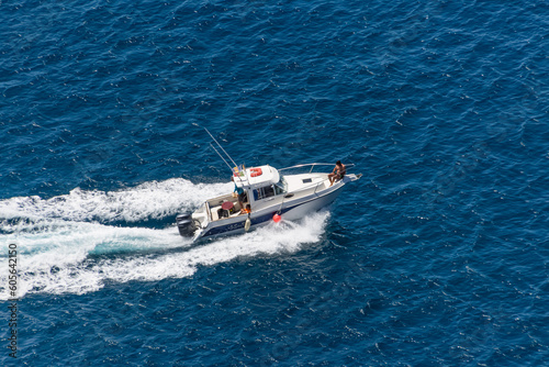 Aerial view of a private recreational boat with people sailing, game boat on the Atlantic ocean, coast at Madeira Island