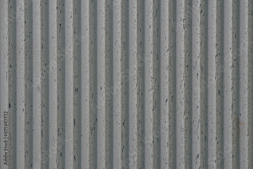 grey concrete wall with deep textured 3d lines vertical, diagonal or horizontal with a lot of copy space for text background