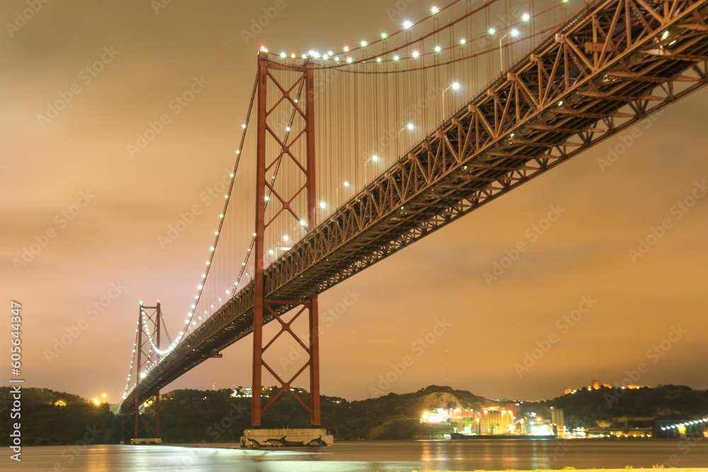 Low angle shot of illuminated bridge over river against the sky Low angle shot of illuminated bridge over river against the sky