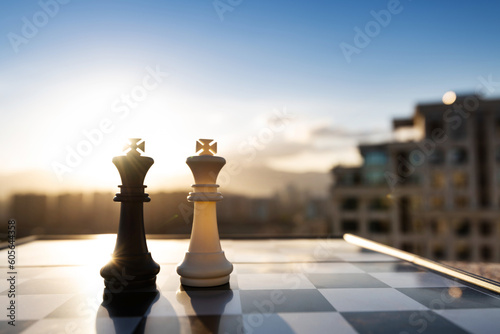 Two chess kings on city background