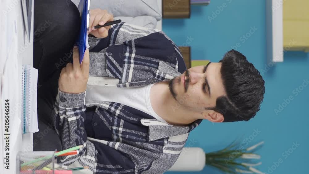 Vertical Video of Home office worker taking notes while looking at computer. Vertical Video of Home office worker taking notes while looking at computer.