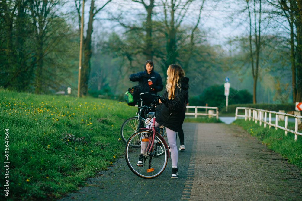 Group of cyclists makings stop in the park during bike trip.