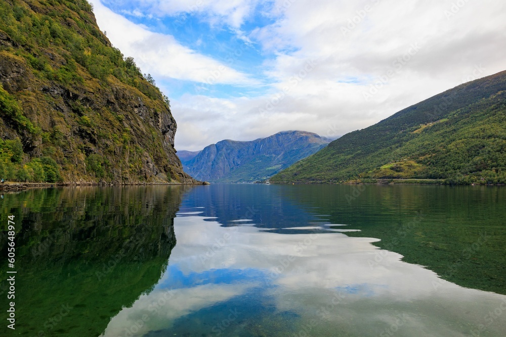 Beautiful shot of a lake surrounded by mountains under a cloudy sky