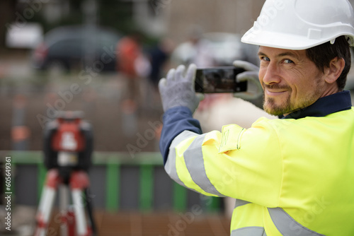 engineer architect on construction site take photo on smartphone