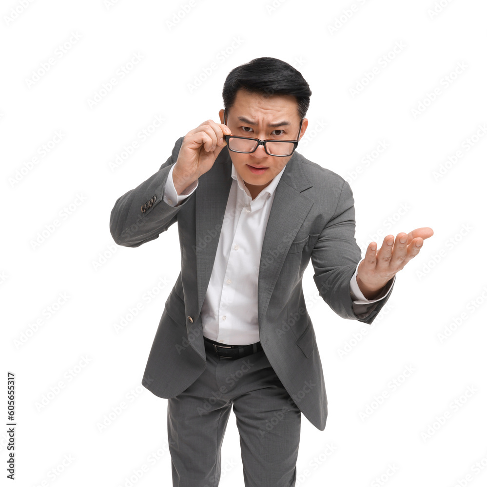 Angry businessman in suit wearing glasses on white background, low angle view Angry businessman in suit wearing glasses on white background, low angle view