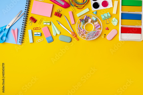 Flat lay composition with different school stationery on yellow background, space for text. Back to school