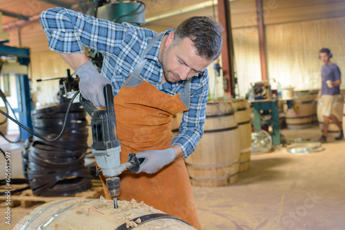 Slika na platnu Man drilling hole into oak barrel