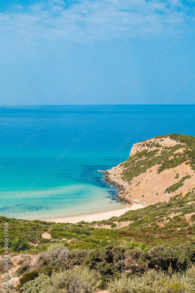 Vertical aerial view of a beautiful seashore with a rocky cliff in Kef Abbed, Tunisia