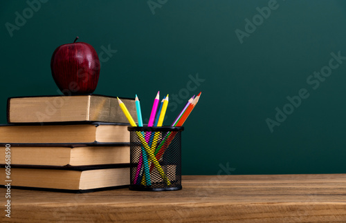 School supplies in front of the blackboard