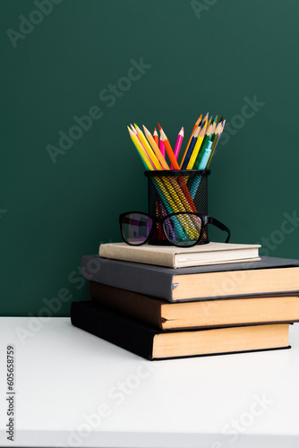 School supplies in front of the blackboard