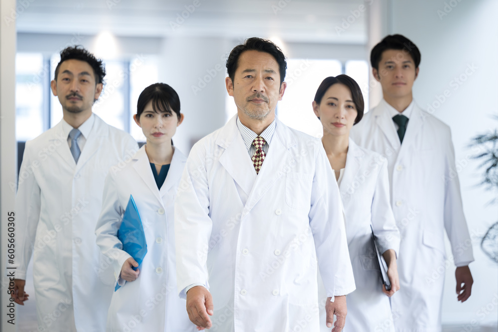 Image of multiple doctors and researchers where they all walk in a set of images Image of multiple doctors and researchers where they all walk in a set of images