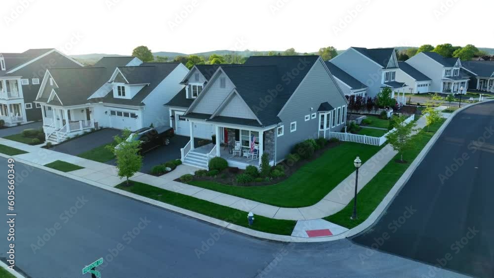 American flag waving on front porch of quaint one family home in