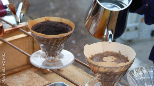 Pouring traditional coffee in a glass with paper filter on the Sri Lanka street