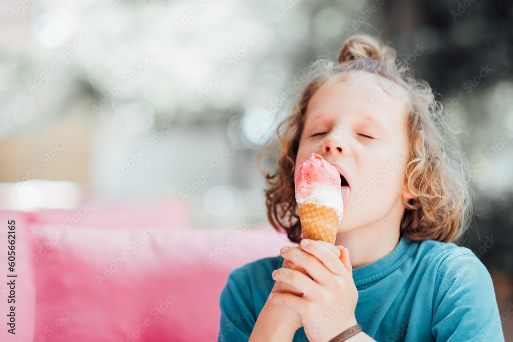 Closeup portrait of boy eating waffle cone ice cream with appetizing. Child licking ice cream. Closeup portrait of boy eating waffle cone ice cream with appetizing. Child licking ice cream.