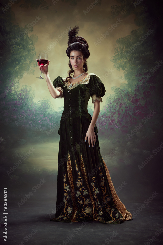 Portrait of beautiful young girl, princess, royal person in elegant dress standing with glass of red wine against dark vintage background. Concept of history, renaissance art, comparison of eras
